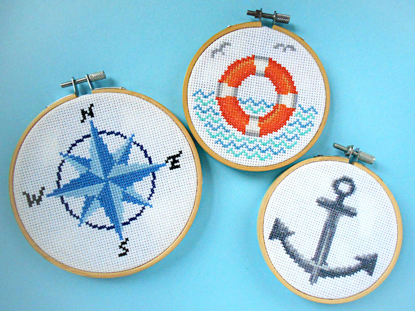 Nautical-themed cross stitches - compass, lifebuoy, anchor