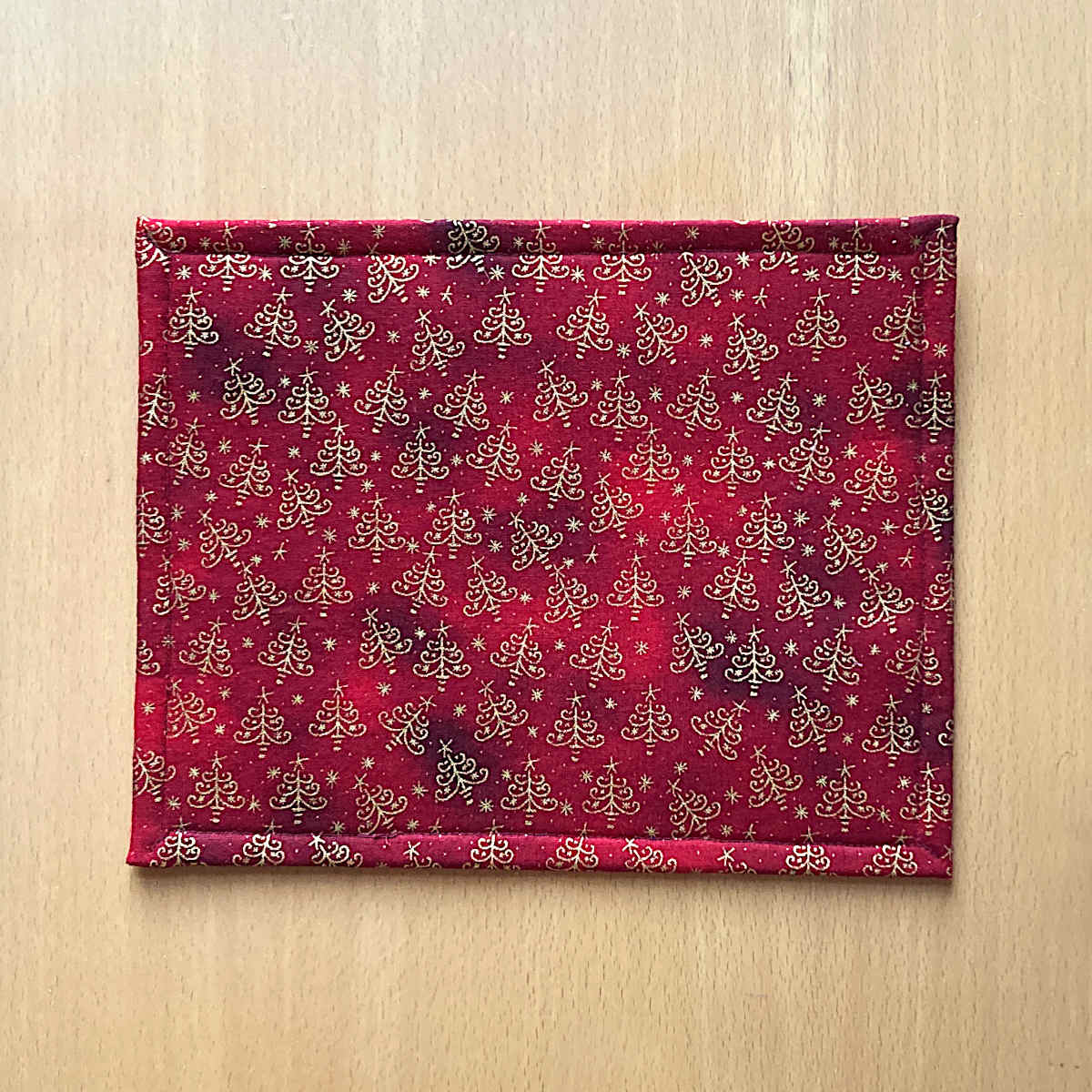 Back of small Project Bag, showing red fabric with golden christmas tree print