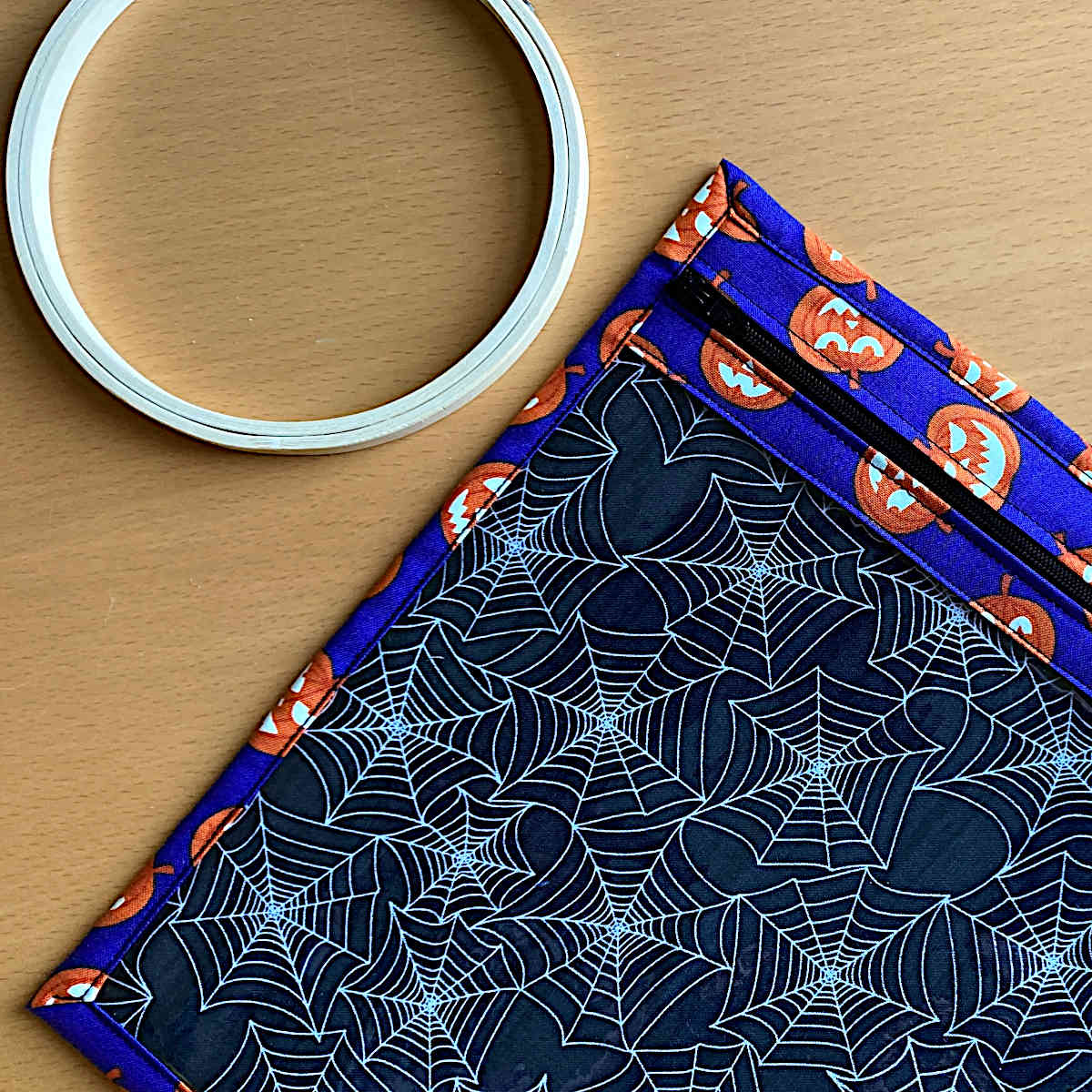 Project bag made out of fabric with spider web pattern and Halloween pumpkins 