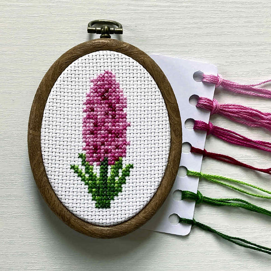 pink pearl hyacinth cross stitch in oval embroidery hoop