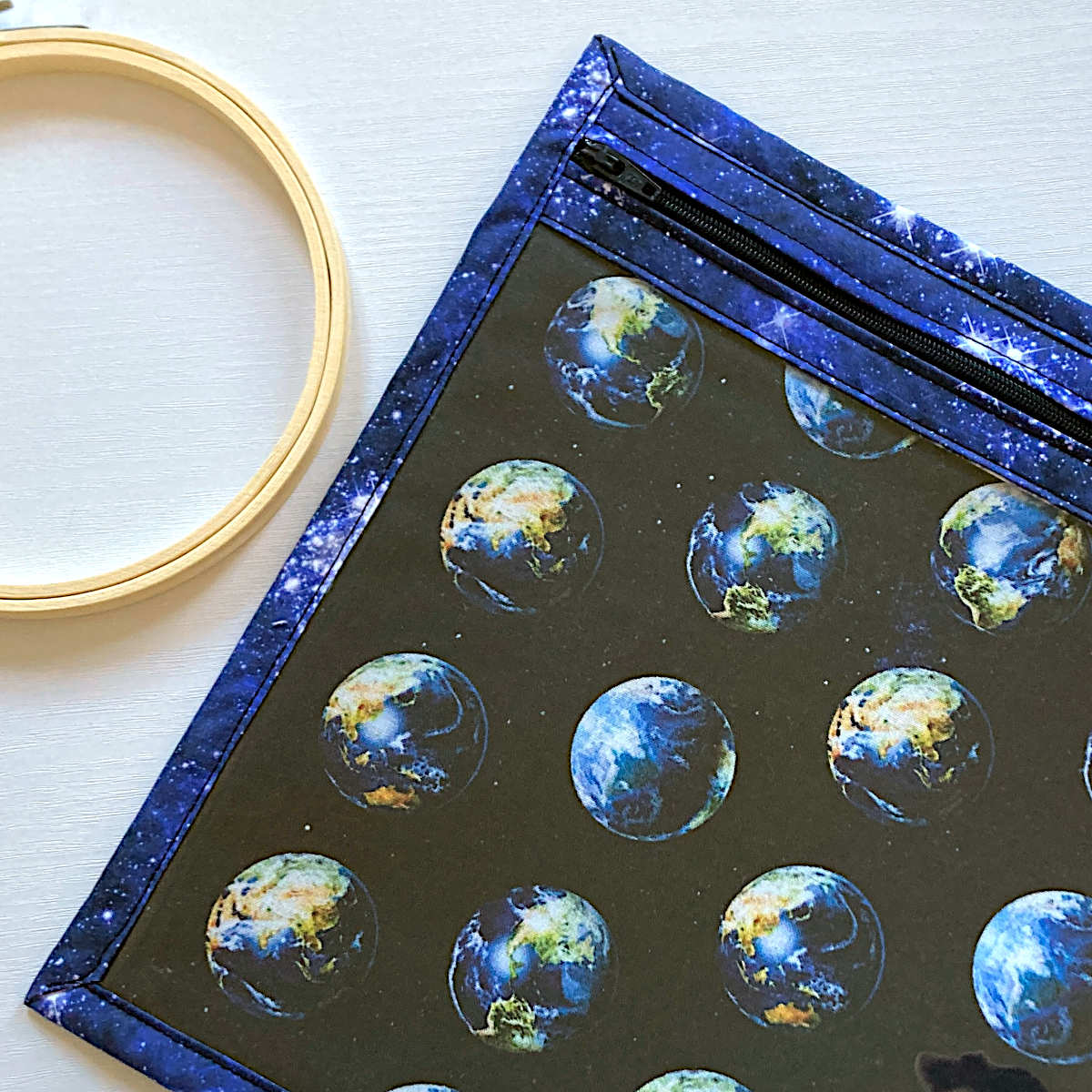 blue vinyl fronted project bag with zip, planet earth and space print fabrics