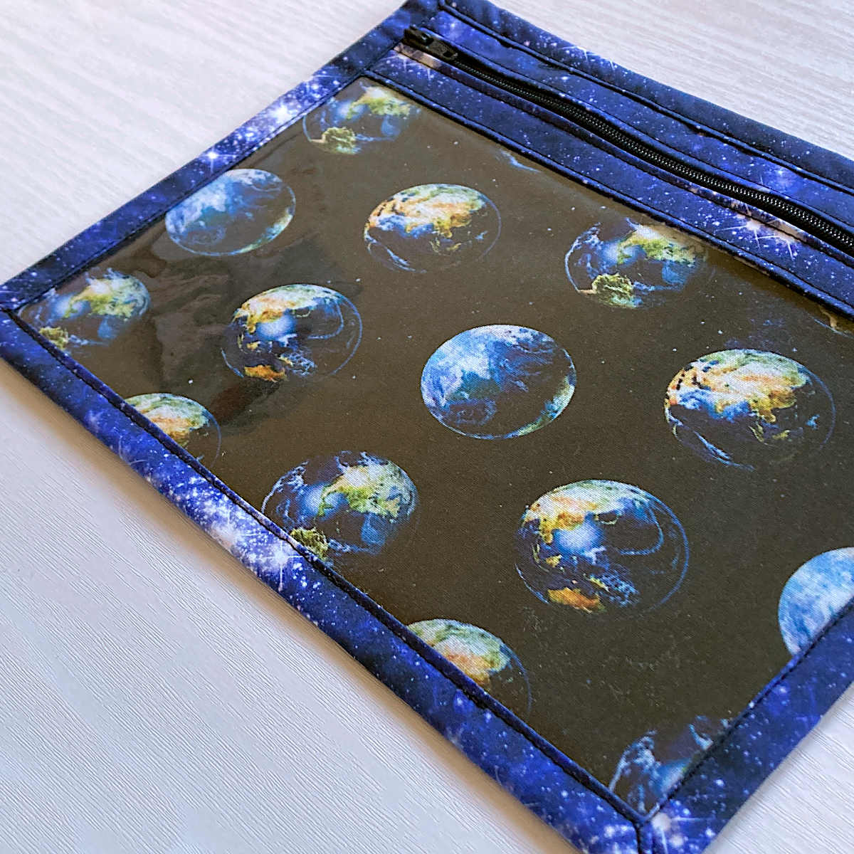 blue vinyl fronted project bag with zip, planet earth and space print fabrics