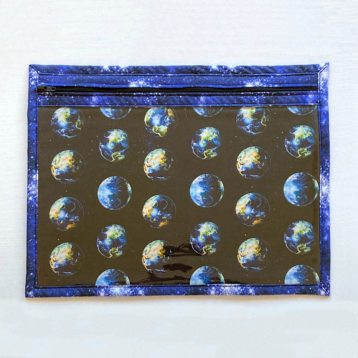 blue vinyl fronted project bag with zip, planet earth and space print fabrics