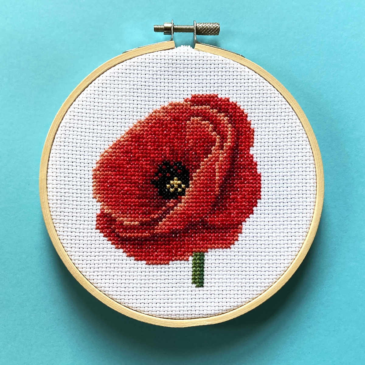 Red poppy cross stitch in a 5 inch embroidery hoop