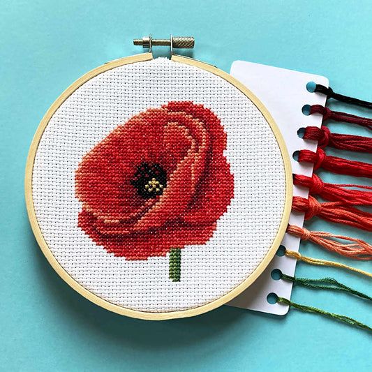 Red poppy cross stitch in 5 inch hoop with DMC embroidery threads