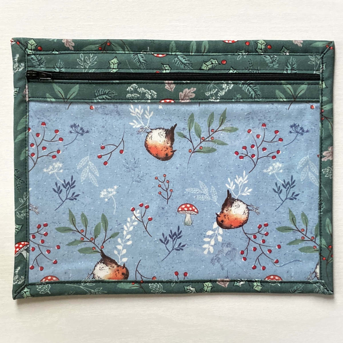 Small project pouch with green foliage outer fabric, vinyl & zip front and robin lining fabric