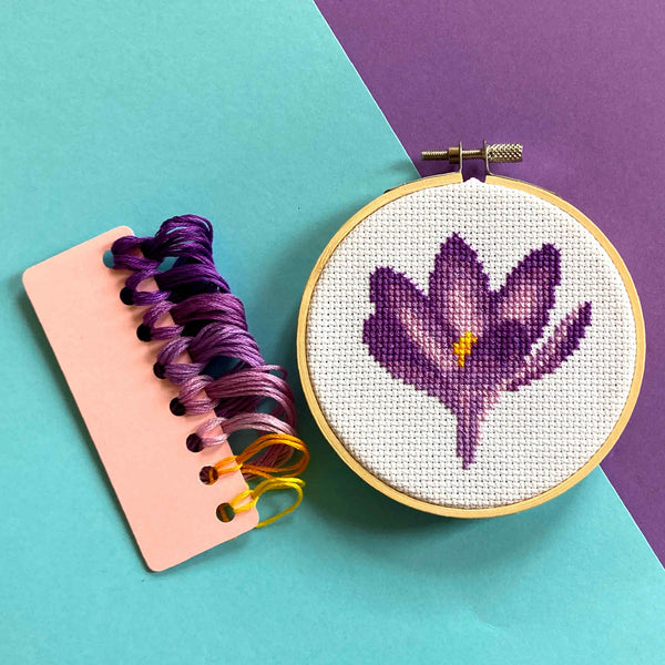 purple crocus cross stitch in embroidery hoop with DMC threads