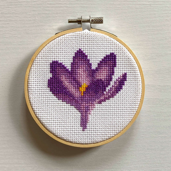 Purple crocus cross stitch in embroidery hoop (finished example)