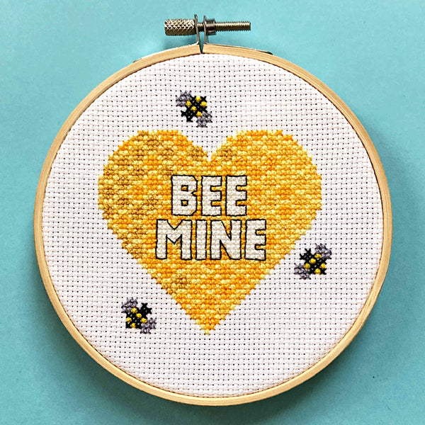 'Bee Mine' pun cross stitch on honeycomb heart in embroidery hoop