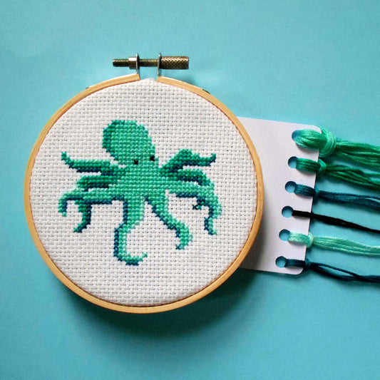 Green-blue octopus cross stitch in hoop with DMC threads
