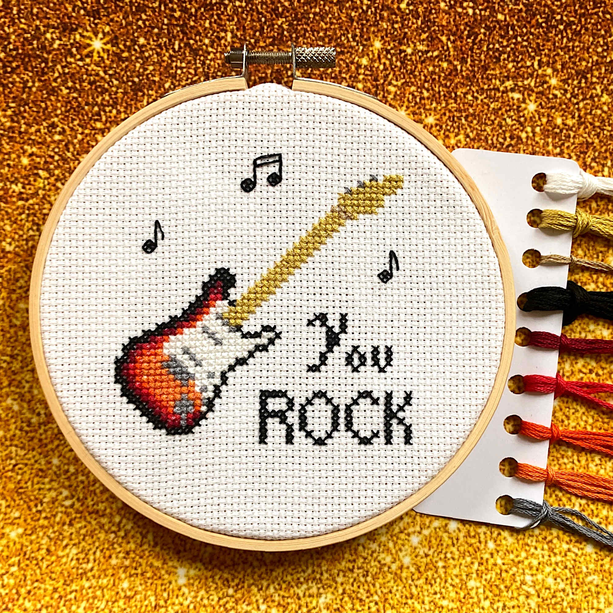 Guitar Cross Stitch with "you rock" caption and musical notes
